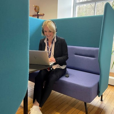 Person using a laptop in a booth